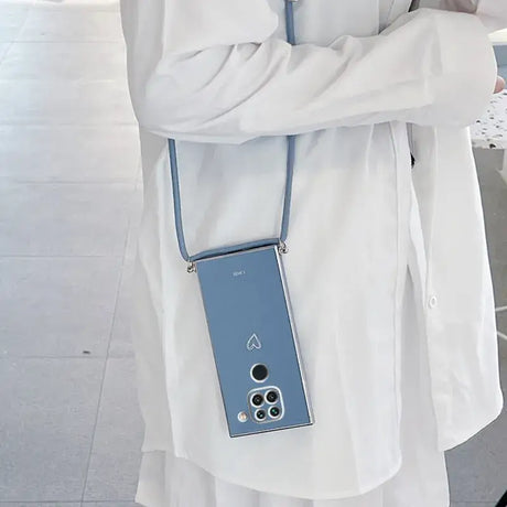 A woman in a white coat holding a blue cell phone