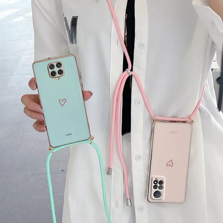 A woman wearing a white coat holding a pink and green phone case