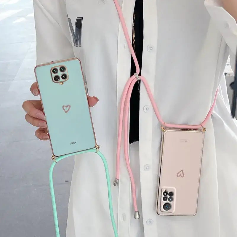 a woman wearing a white coat holding a pink and green phone case