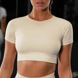 a woman in a white crop top and black shorts