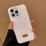 a woman holding a white iphone case with a gold glitter