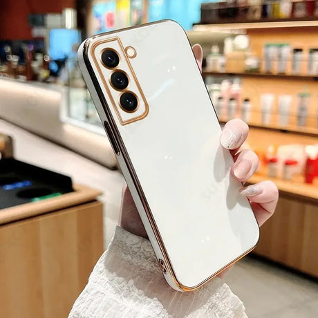 A woman holding a white iphone case