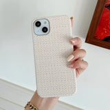 A woman holding a white iphone case