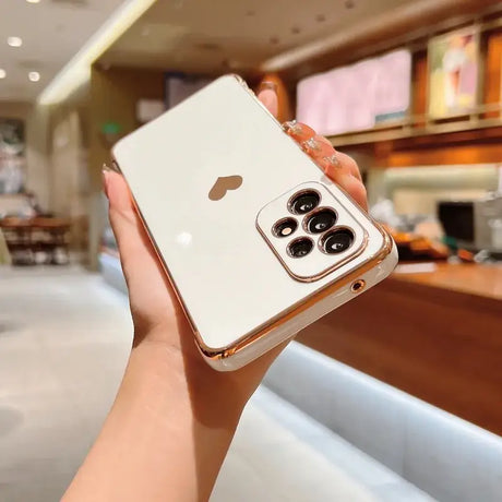 A woman holding up a white iphone case