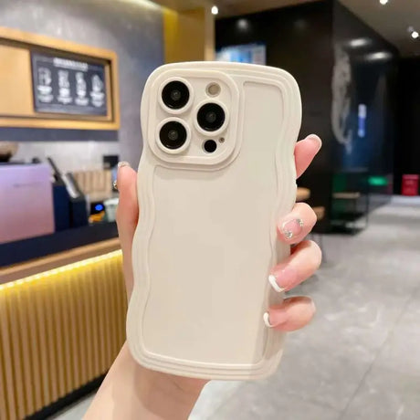 A woman holding a white iphone case