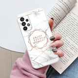 a woman holding a white marble phone case with the words enjoy moment