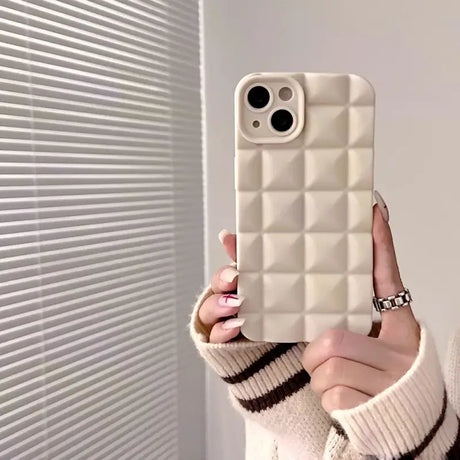 A woman holding up a white phone case