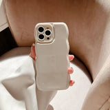 a woman holding a white phone case
