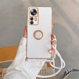 a woman holding a white phone with a gold ring