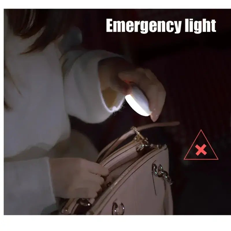 a woman holding a white purse with a light on it