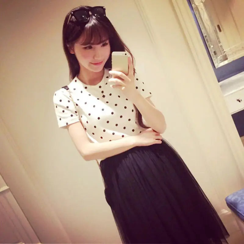 a woman in a white shirt and black skirt