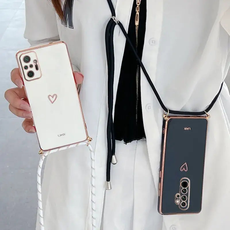 A woman wearing a white suit and black tie holding a cell phone