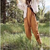 a woman in a white jacket and brown pants