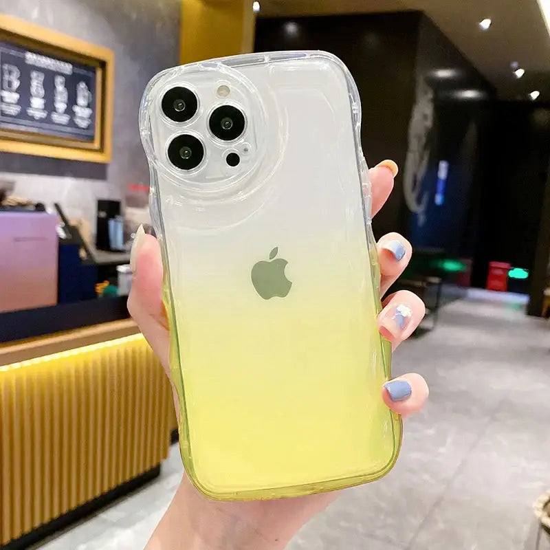 a woman holding up a yellow iphone case