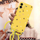 a woman holding a yellow phone case with hearts on it