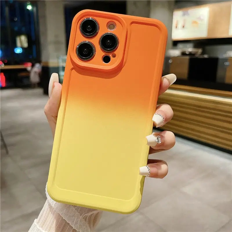 a woman holding a yellow phone case