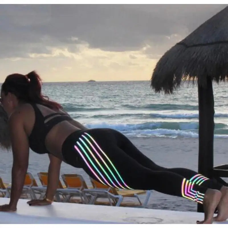 a woman doing yoga on the beach