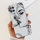 a woman’s face is drawn on a white phone case