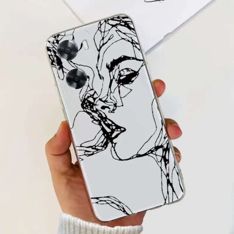a woman’s hand holding a phone case with a black and white drawing of a woman