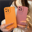 two women holding up their iphone cases