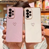 two women holding up their iphones with the same heart