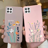 two women holding up their phone cases with flowers and plants
