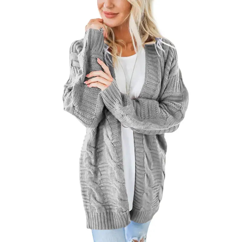 a woman wearing a grey cardigan sweater