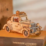 a wooden model of a car on top of a book