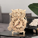 a wooden clock with an owl face on it