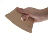 a hand holding a piece of brown paper