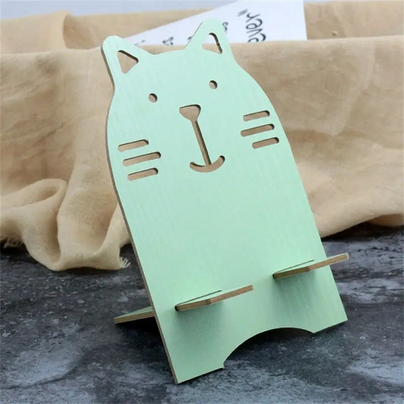 a cat shaped book stand with a green paper cut out