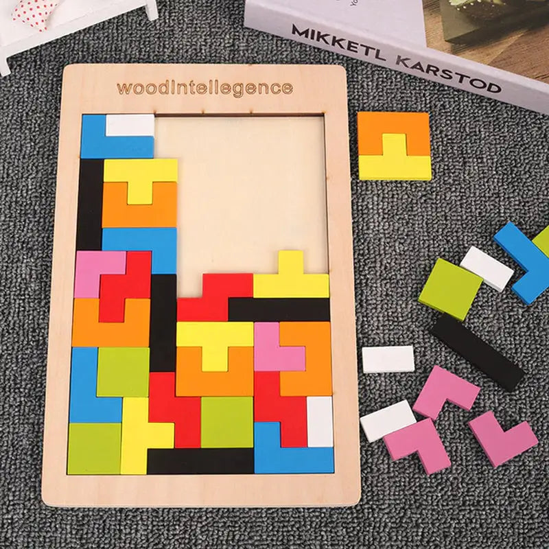 a wooden puzzle with colorful squares and a box