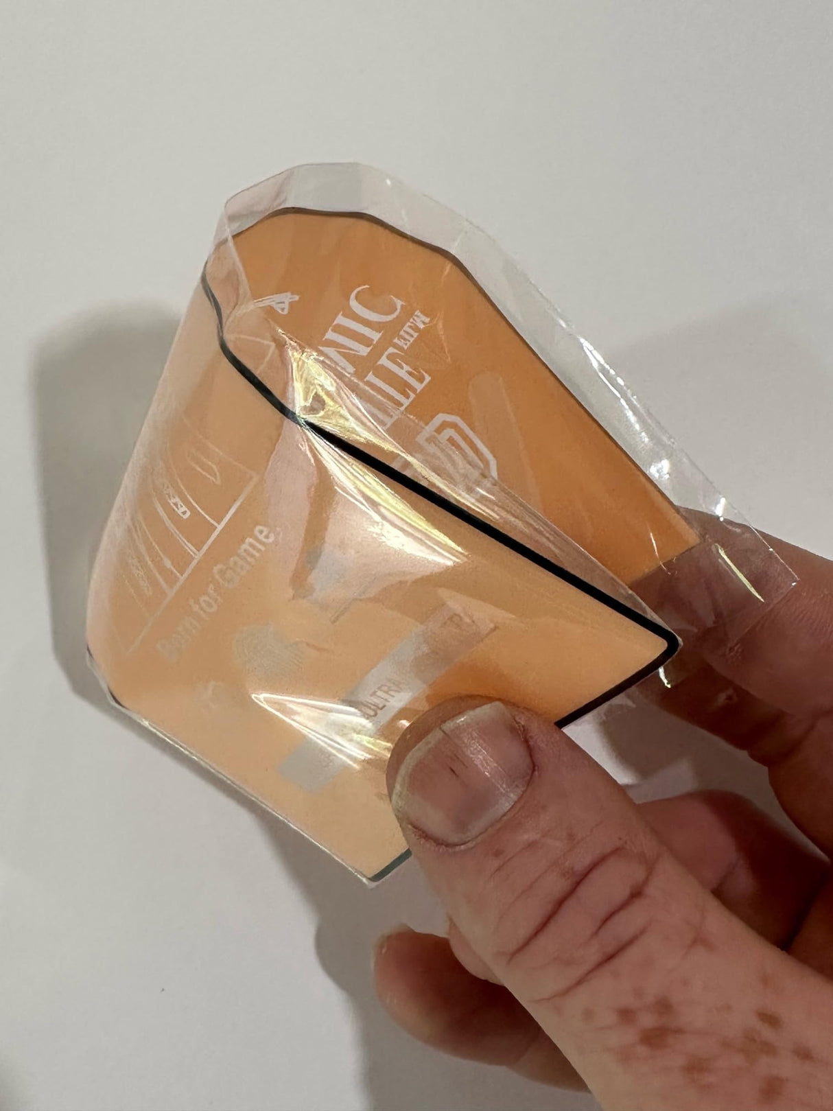 Wrapped, peach-colored perfume sample.