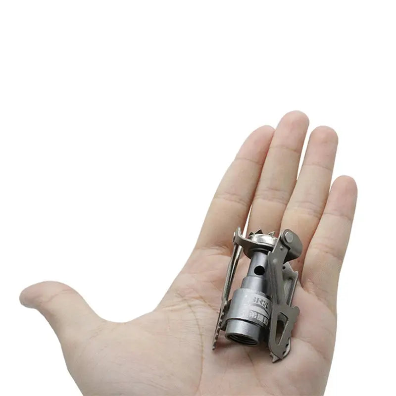 a hand holding a small silver object