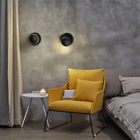 a yellow chair in front of a grey wall