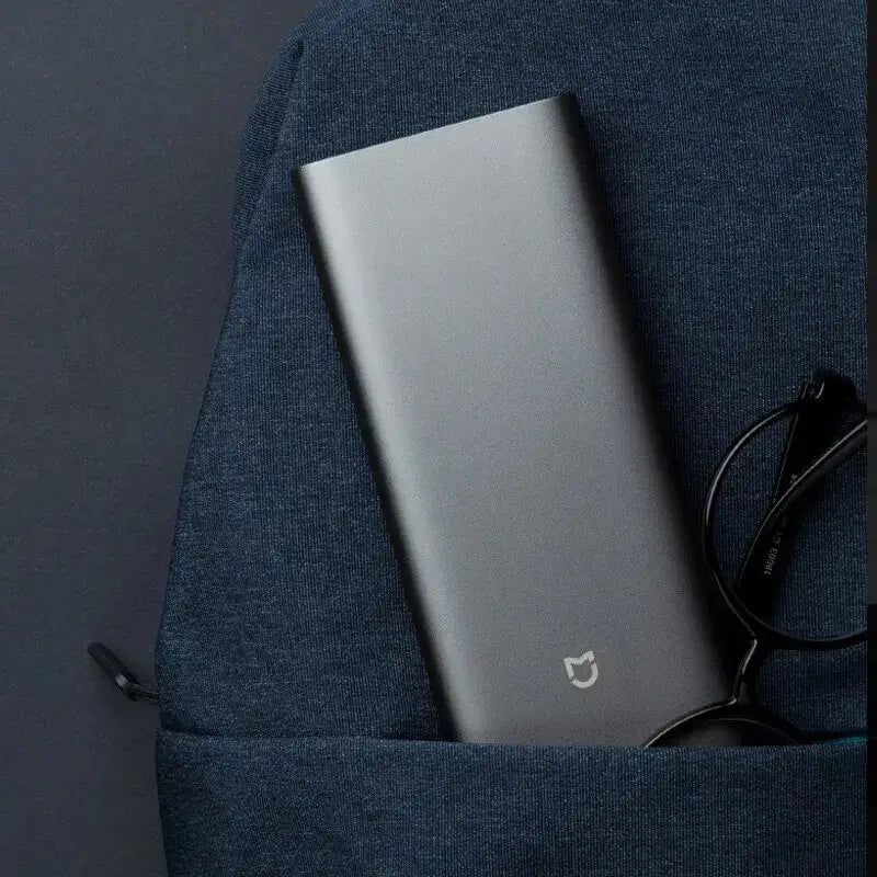 a close up of a laptop in a backpack with a pair of glasses