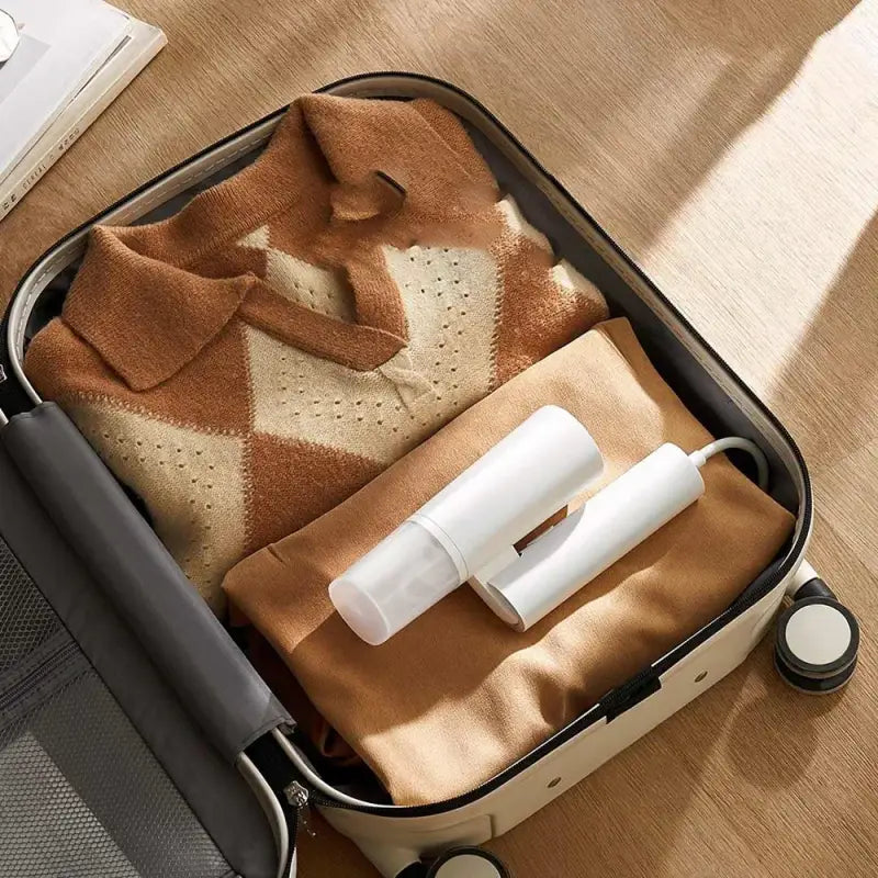 a suitcase with a blanket and toilet paper