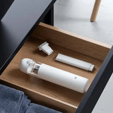 a white electric toothbrush and a wooden drawer