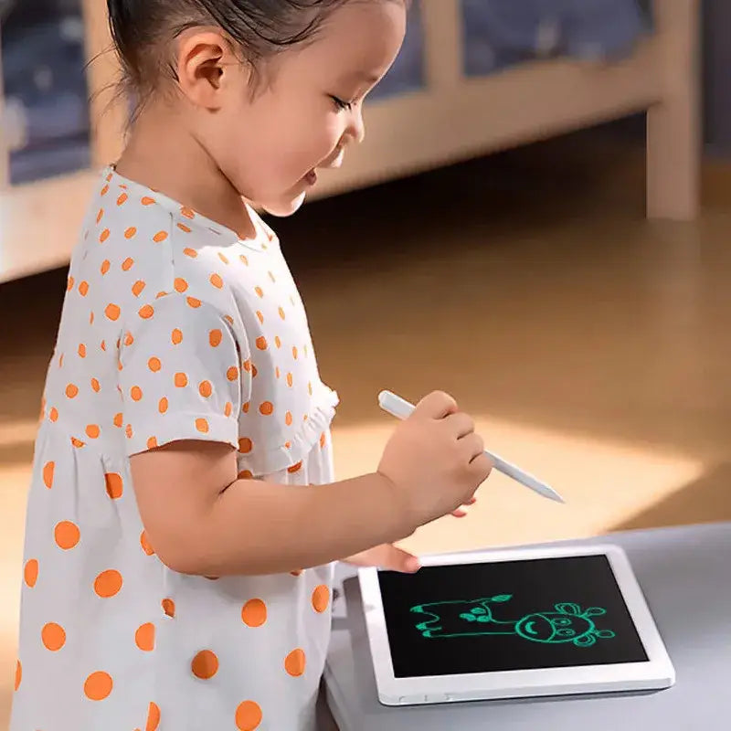 a little girl is using a tablet