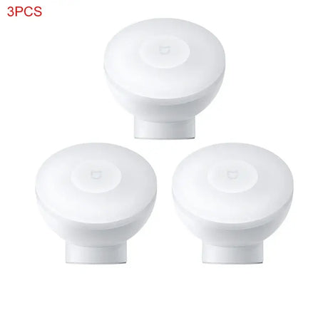 three white knobs with a white cover on a white background