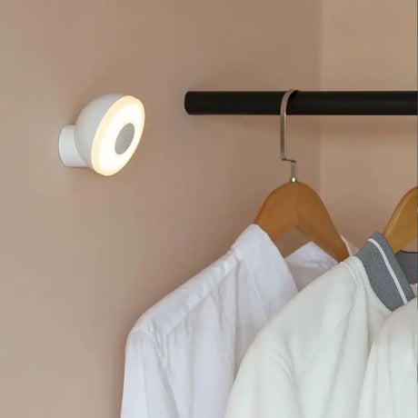 a white shirt hanging on a rail in a closet