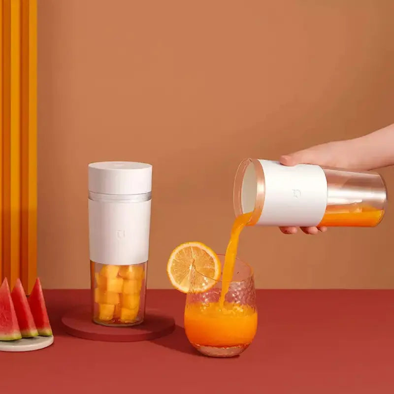 a person pouring orange juice into a glass