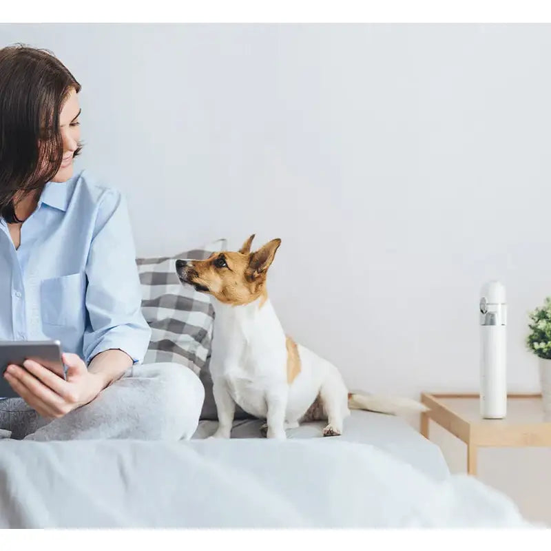 a woman sitting on a couch with her dog