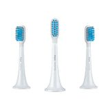 three toothbrushs with blue and white brushes