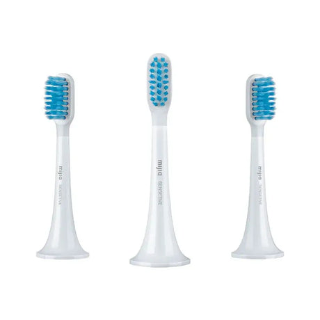 three toothbrushs with blue and white brushes