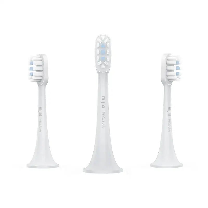 three white toothbrushs with a white background