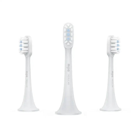 three white toothbrushs with a white background