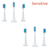 four toothbrushs with blue and white brushes