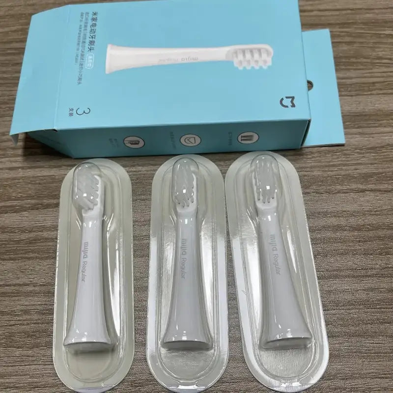 a pair of white plastic spoons and a box of clear plastic spoons