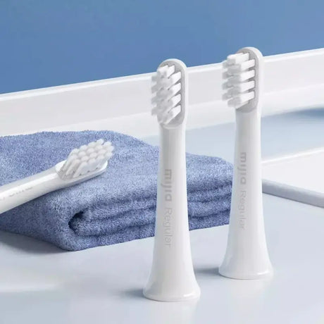 two toothbrushs sitting on a counter